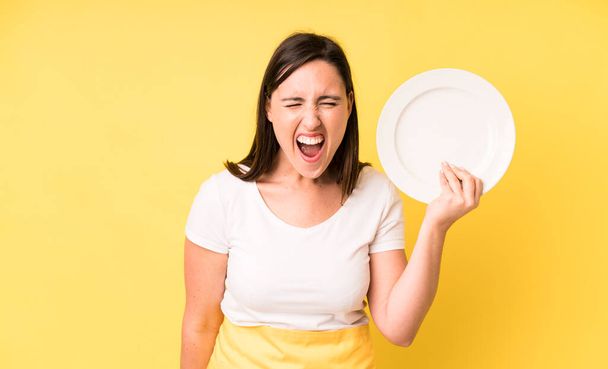young adult pretty woman home chef with empty plate - Fotoğraf, Görsel