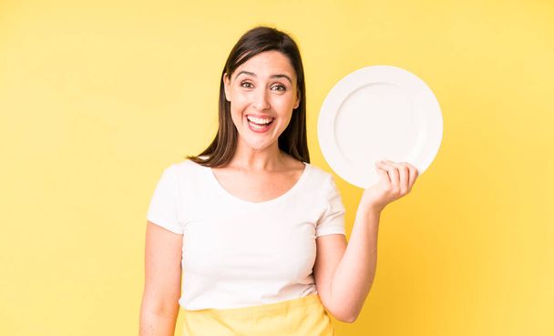 young adult pretty woman home chef with empty plate - 写真・画像