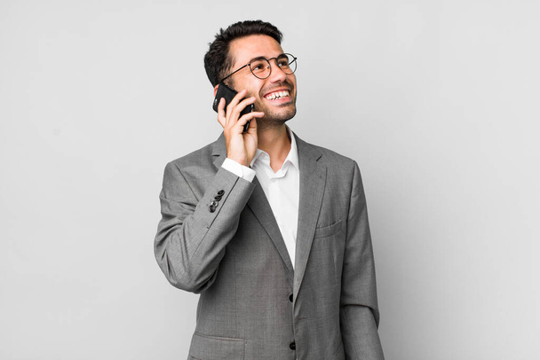 young adult handsome hispanic man business concept with a mobile phone - Fotó, kép