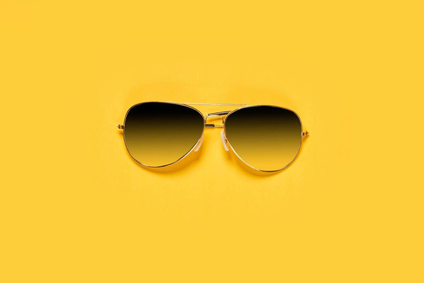 Classic sunglasses on bright yellow background - Photo, Image