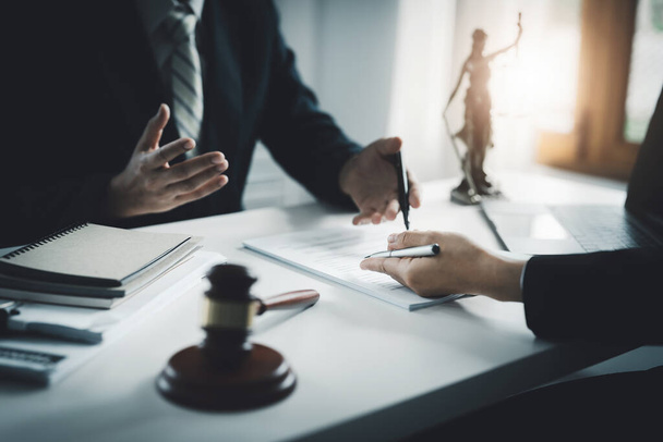 Law, Consultation, Agreement, Contract, Attorney or Lawyer holding a pen is consulting with a client to explain the pattern of answering questions before going to court to decide a lawsuit. - Photo, image