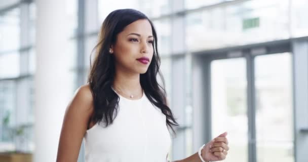 Because you can be professional and personable. 4k video footage of a young businesswoman showing thumbs up while walking through a modern office. - Imágenes, Vídeo