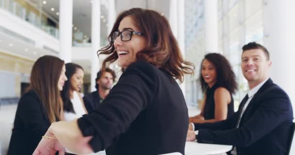 Each day is a chance to shine brighter in your career. 4k video footage of a young businesswoman smiling in an office during a meeting with her colleagues in the background. - Video