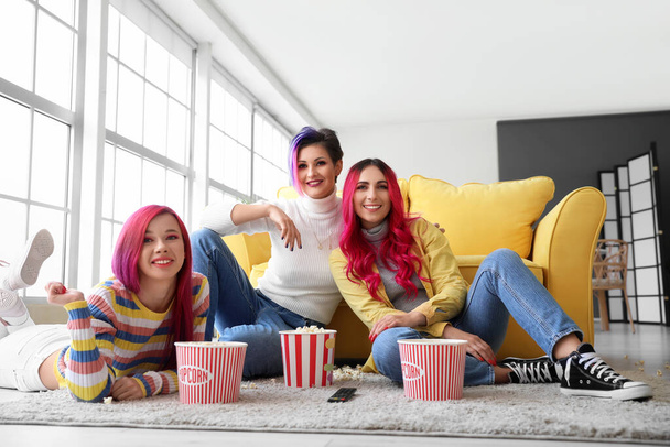 Beautiful women with popcorn watching movie at home - Foto, Imagem