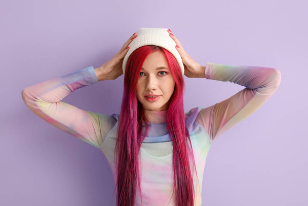 Beautiful young woman with bright hair on lilac background - Fotó, kép