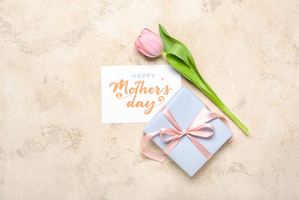 Card with text HAPPY MOTHER'S DAY, gift box and tulip on grunge background - Photo, image