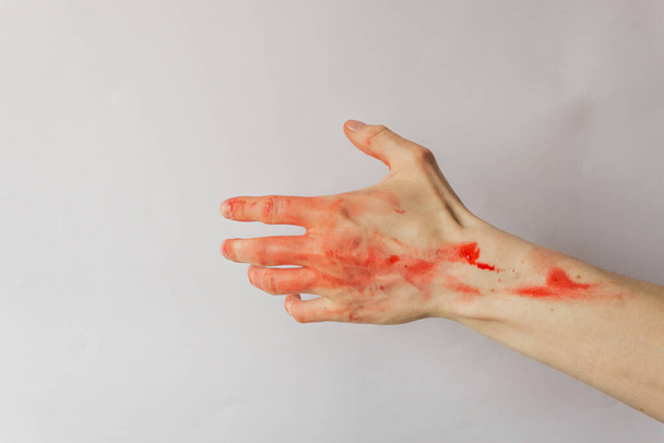Samotny człowiek z czerwoną krwią odizolowany na białym tle. Ręce mordercy i gwałciciela. Masakra w Bucha koło Kijowa. Zakończyć wojnę i przemoc na Ukrainie. - Zdjęcie, obraz