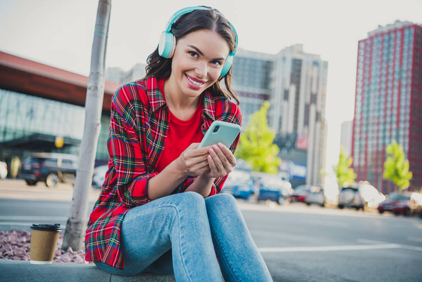 Portrait of attractive cheerful girl using device gadget listening to pop hit single spending weekend outdoors - Foto, afbeelding
