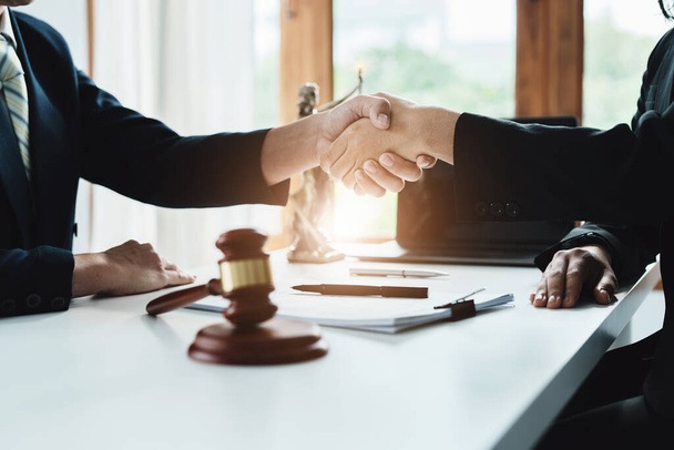 Law, consultation, agreement, contract, lawyer or attorney shakes hands to agree on the clients offer to be hired to fight the parties in court. - Fotoğraf, Görsel