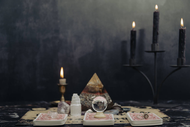 Mystic ritual with Ouija and candles. Devils board concept, black magic or fortune telling rite with occult and esoteric symbols. Mystical rituals and occult sciences. - Фото, зображення