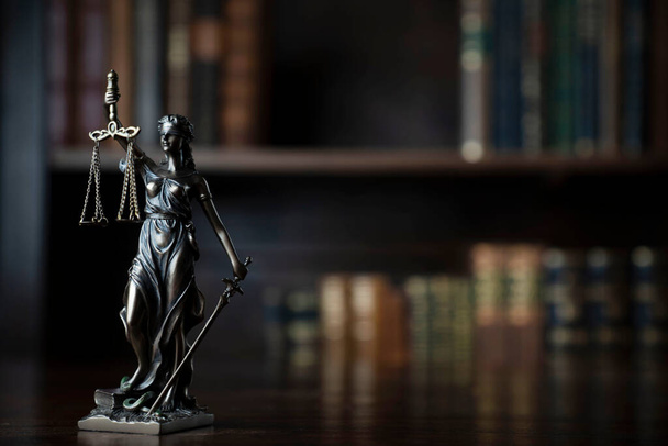 Judge office. Themis statue on the judge desk. Book shelf in the background. - Foto, Imagem