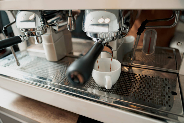 Professional coffee machine brewing coffee in cafeteria - Foto, Imagen