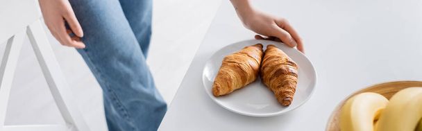 cropped view of woman near plate with delicious croissants, banner - Photo, Image