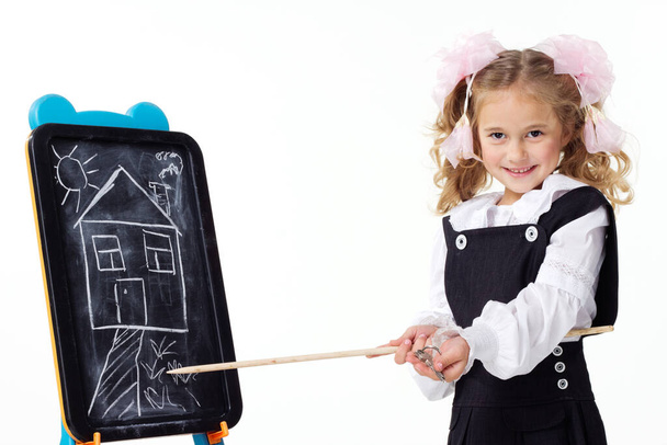 Young girls with a blackboard and a drawing of a new house. In the hands of the girl are the keys to a new home. Concept photo. - Fotoğraf, Görsel