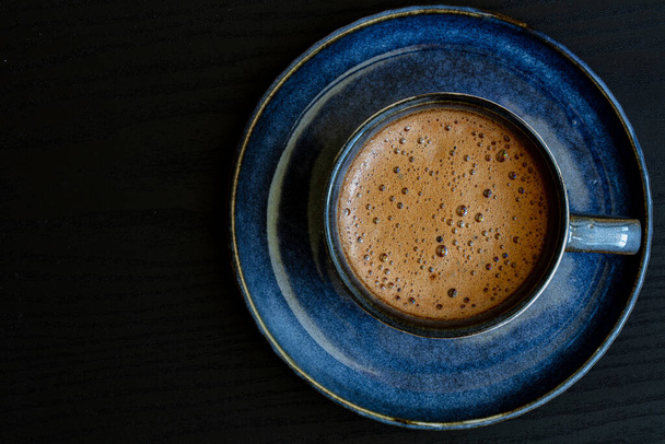 blue cup of coffee on black background for design purpose - Foto, afbeelding