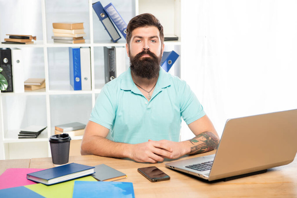 Serious professional man sitting at office desk, manager - Photo, image