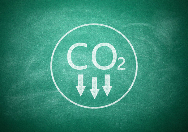Reduce carbon emissions. Chemical formula CO2 on green chalkboard - Zdjęcie, obraz