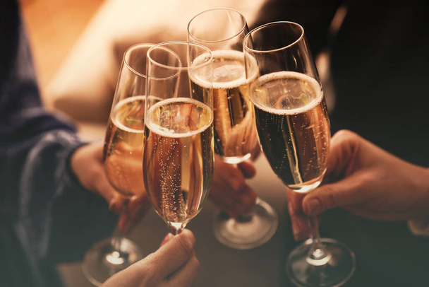 People clinking glasses with sparkling wine indoors , closeup - Fotografie, Obrázek