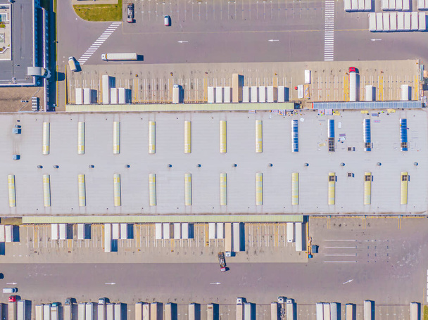 Aerial Shot of Industrial Loading Area where Many Trucks Are Unloading Merchandis - Photo, Image
