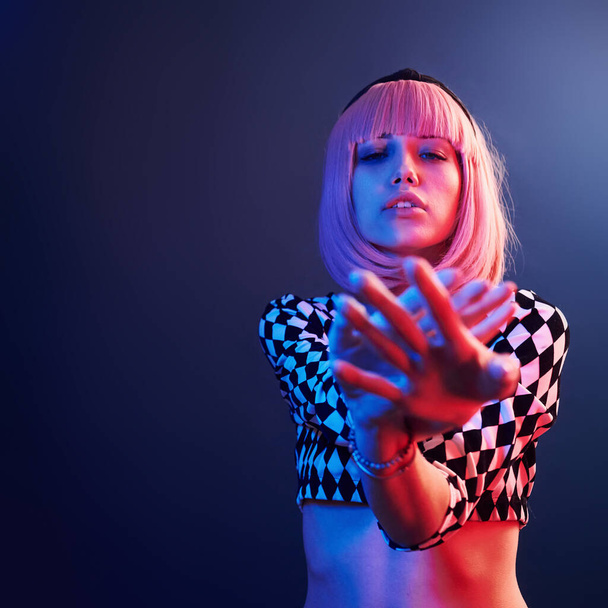 Portrait of young girl with blond hair in red and blue neon in studio. - Foto, immagini