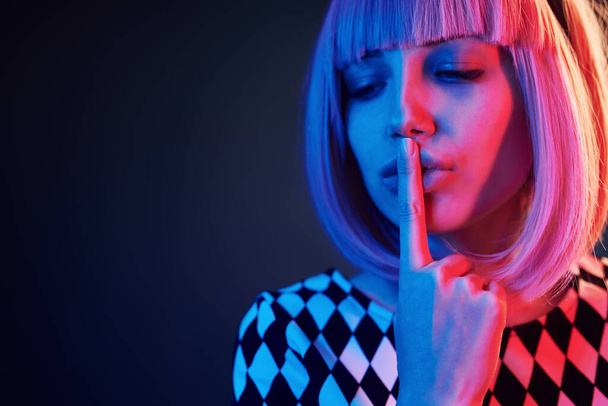 Portrait of young girl with blond hair in red and blue neon in studio. - Foto, imagen