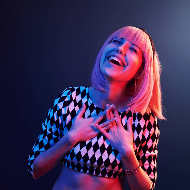 Portrait of young girl with blond hair in red and blue neon in studio. - Фото, изображение
