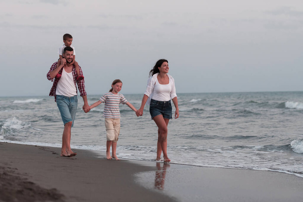 Happy young family have fun and live healthy lifestyle on beach. Selective focus  - Фото, изображение