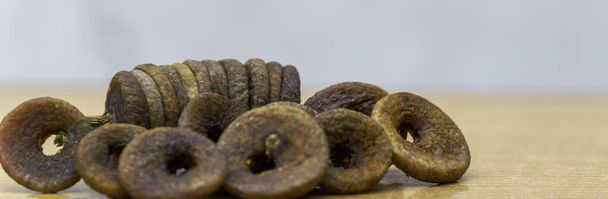 Beautiful Dried Figs are isolated on a wood background. Dried Figs or Anjeer fruit from India, Pakistan, Indonesia, and Asia is a healthy nutritional food - Photo, Image