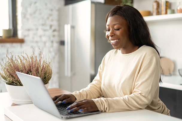 African-American female using computer for work online remotely, received emails - Photo, image