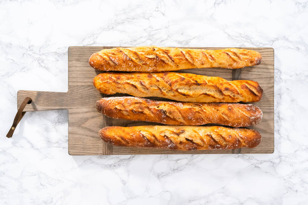 Flat lay. Freshly baked small French baguette bread. - Foto, Imagen