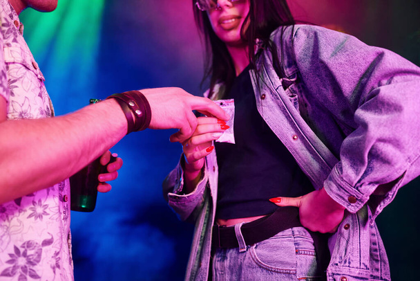Young girl buying drugs inside of night club at party time. - Foto, immagini