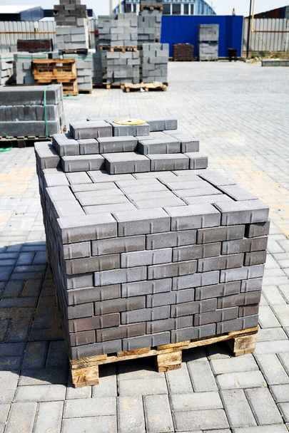 concrete paving slabs stacked on pallets outdoor of workshop - Photo, image