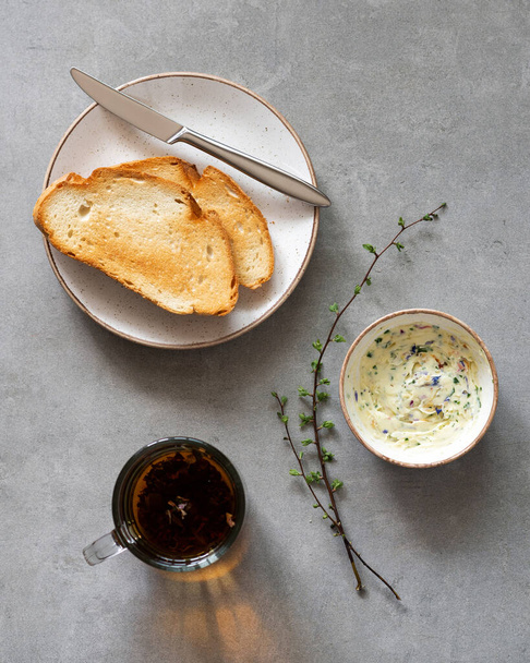 Sandwiches with herbs butter on a gray background. Herb butter in a bowl on concrete background. Healthy homemade herb butter and bread  - Foto, imagen