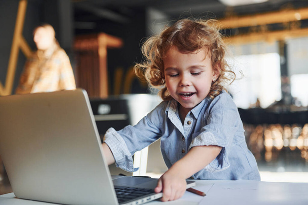 Smart child in casual clothes using laptop for education purposes or fun. - Φωτογραφία, εικόνα