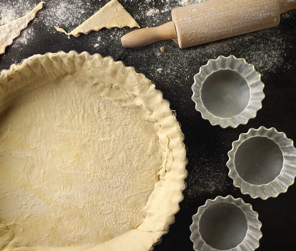 freshly maked dough in a baking tart form  - Photo, Image