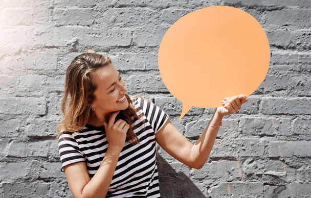 Oh, öyle mi? Neşeli genç bir kadının dışarıda tuğla duvara karşı konuşma baloncuğu tutarken görüntüsü.. - Fotoğraf, Görsel