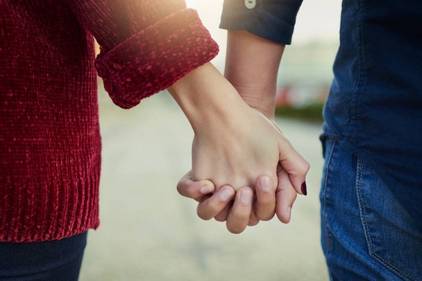 True love means never letting go. Cropped shot of a couple holding hands outdoors. - Foto, Bild