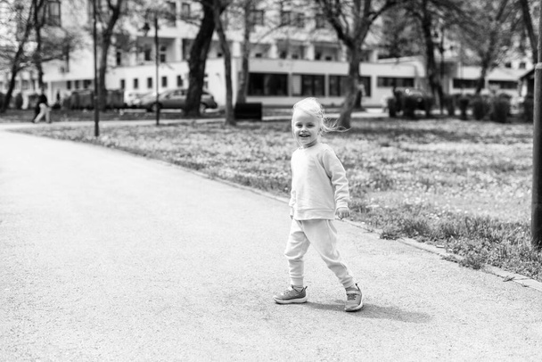 Little Girl Playing in Park - Running and Enjoying in Sunny Day - Happy Moments in Nature - Фото, зображення