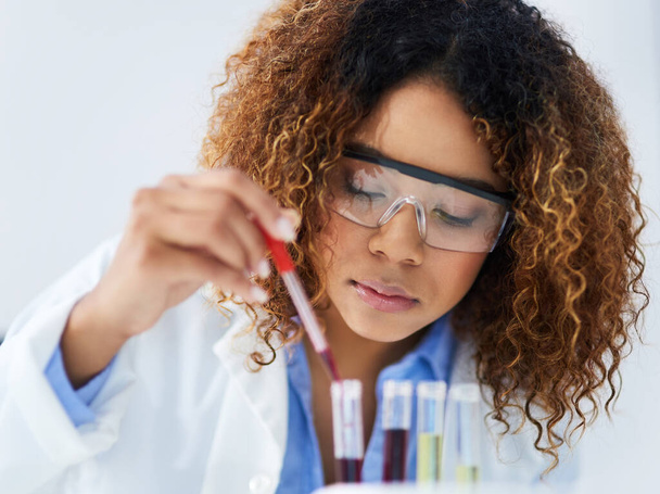 Testing each one individually. Cropped shot of a young female scientist separating samples in the lab. - Φωτογραφία, εικόνα