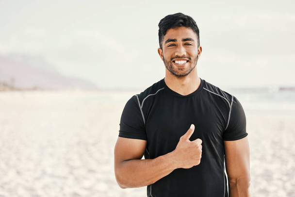 I changed my lifestyle and it changed my life. Shot of a sporty young man showing thumbs up while out for a workout. - Zdjęcie, obraz