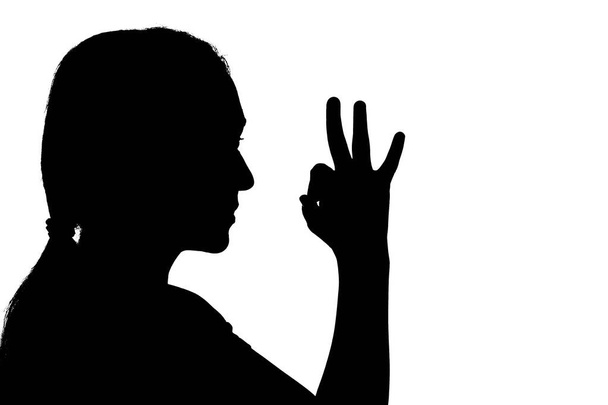 Shadow of a woman showing OK sign hand gesture - Foto, imagen