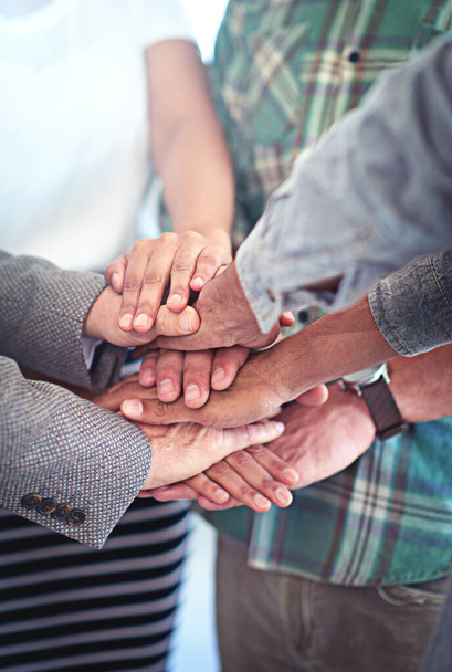 This team has each others backs. Closeup shot of a group of coworkers with their hands in a huddle. - Foto, immagini
