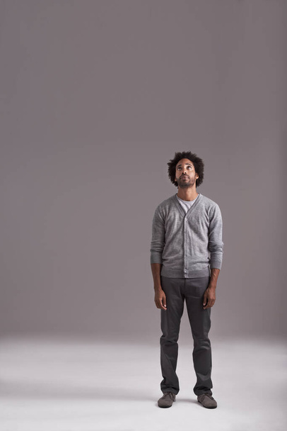 Ive got my sights set on the top. Studio shot of a handsome young man isolated on gray. - Foto, Imagem