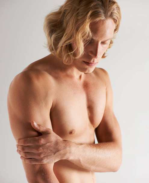 He practices a healthy lifestyle. Studio shot of a handsome young shirtless man. - Foto, Bild