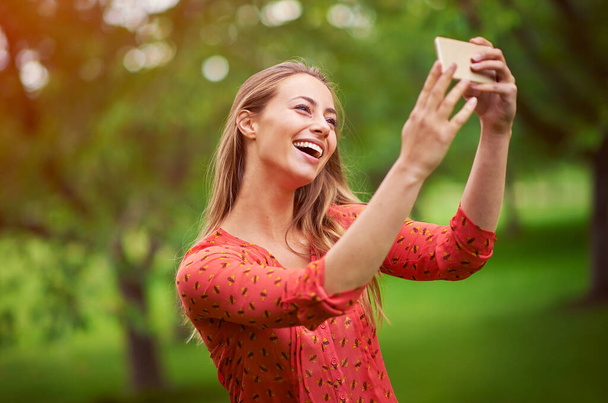 This will make a great profile pic. Shot of a young woman taking a selfie outside. - Photo, Image