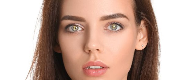 Beautiful young woman with reflection of bitcoin in her eyes isolated on white - Foto, afbeelding