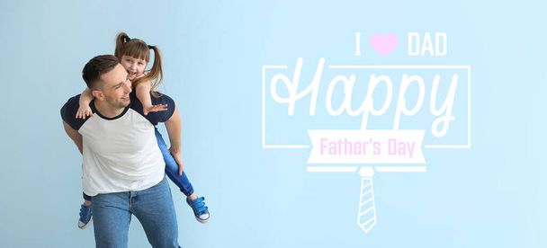 Happy man with little daughter on light blue background. Greeting card for Father's Day - Photo, Image
