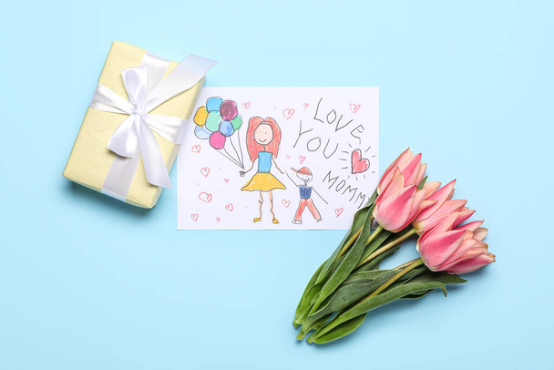 Picture with text LOVE YOU MOMMY, tulips and gift box on blue background - Foto, Imagen