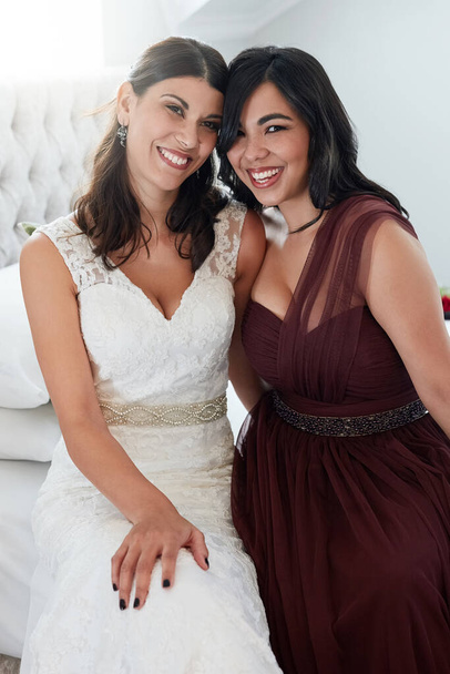 I wouldnt want to share this day with anyone else. Shot of the bride and maid on honor spending time together. - Photo, Image