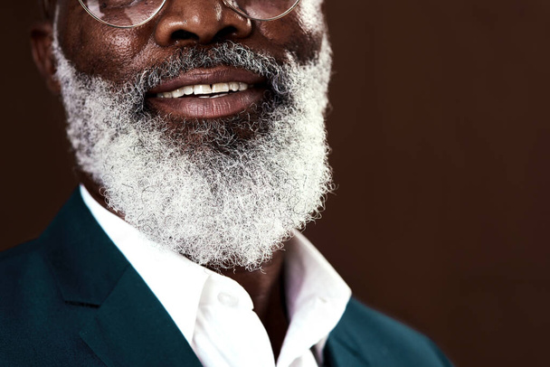 Growing old is a privilege. Cropped shot of a man with grey beard posing against a brown background. - 写真・画像